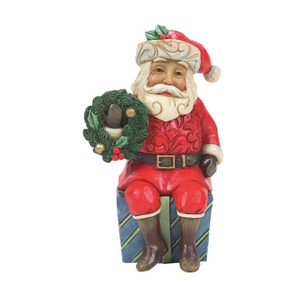 Jim Shore Mini Santa With Wreath Sitting On Gifts Figurine 1 Jim Shore Mini Santa With Wreath Sitting On Gifts Figurine